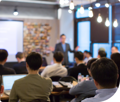 Group of members in team trained by trainer in a conference room